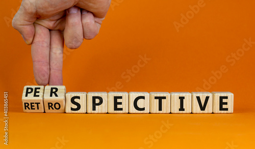 Perspective or retrospective symbol. Businessman hand turns cubes and changes word 'retrospective' to 'perspective'. Beautiful white background. Business and perspective concept. Copy space. photo