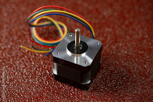 low power stepper motor with wires on a dark colored background