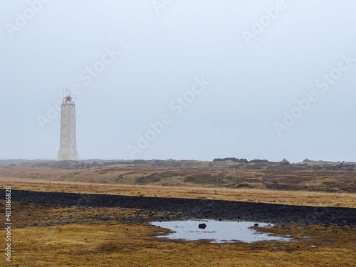 Lighthourse in Iceland,, foggy landscape, winter road trip.