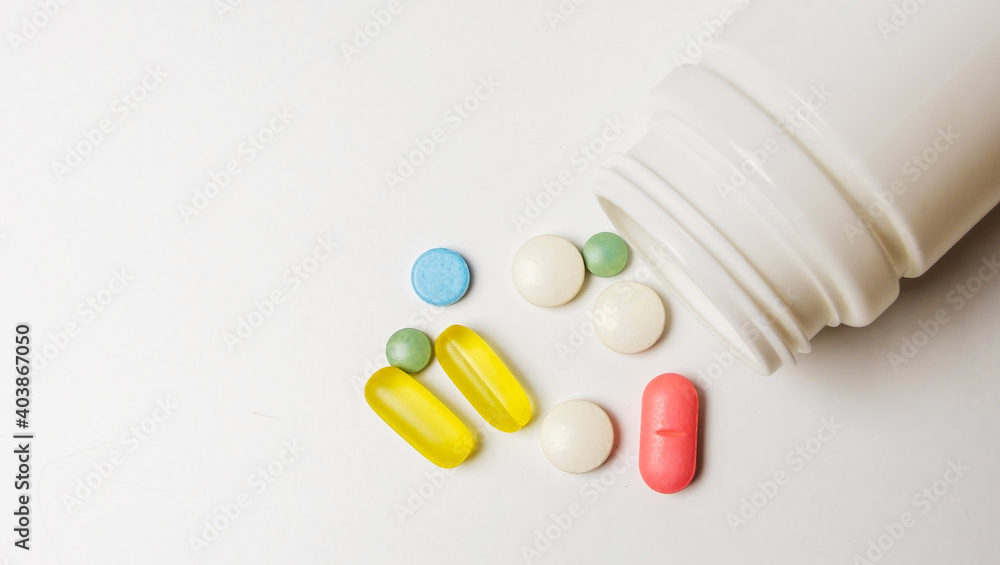 Colorful pills vitamins and antibiotics lie beautifully on a white background Colorful pills vitamins and antibiotics lie beautifully on a white background