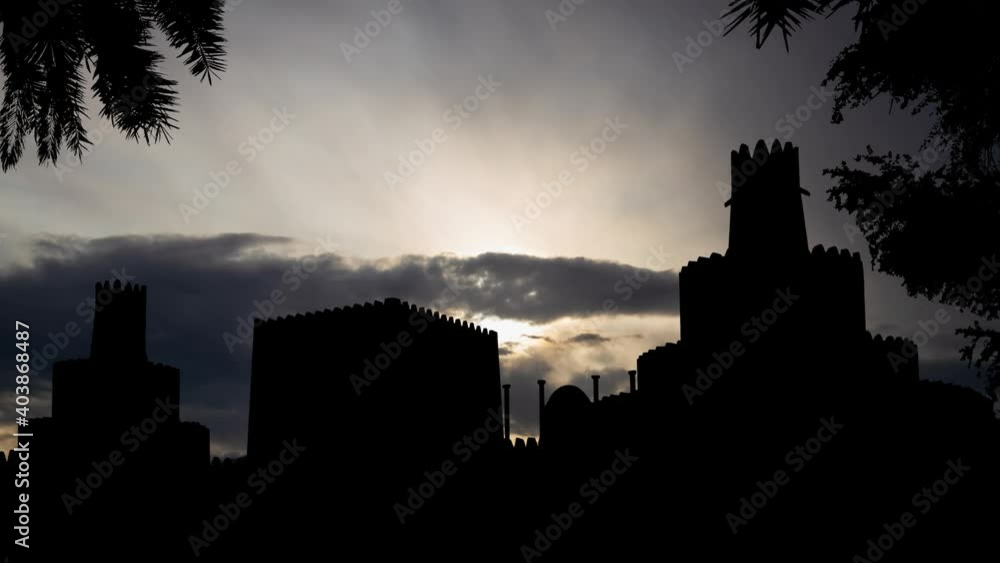 Al-Jahili Fort: Time Lapse at Sunrise with Fast Clouds and Dark Silhouette of Castle, Al Ain, Abu Dhabi, UAE Al-Jahili Fort: Time Lapse at Sunrise with Fast Clouds and Dark Silhouette of Castle, Al Ain, Abu Dhabi, UAE