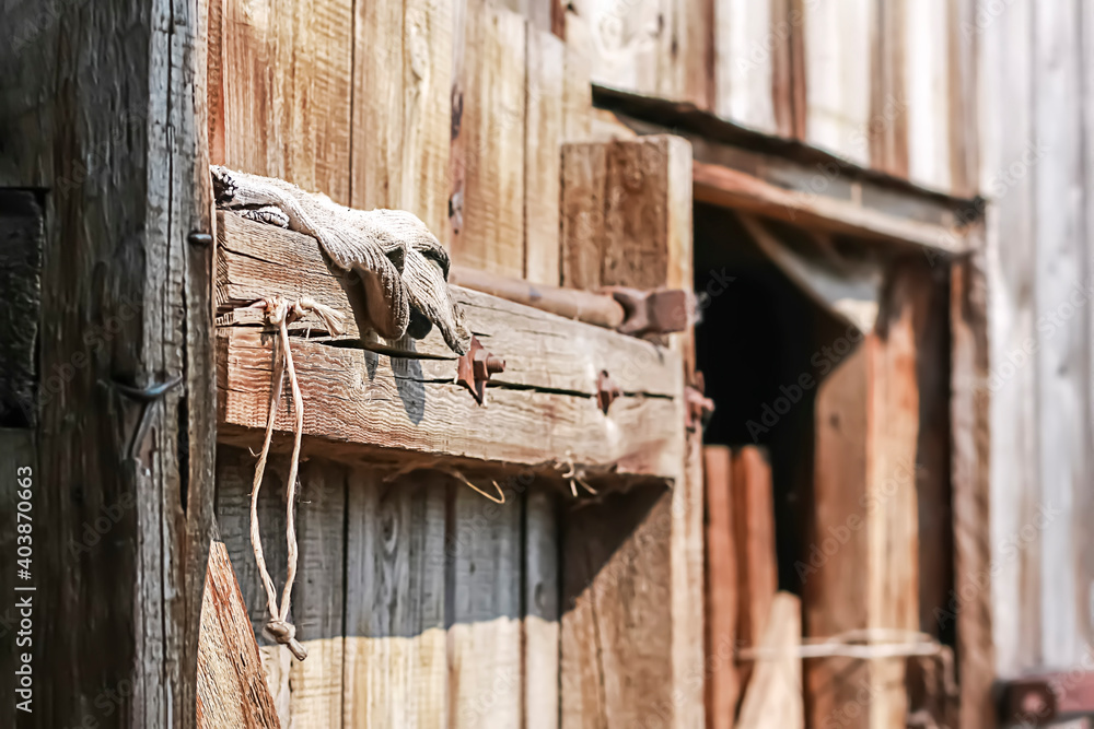 Old wooden barn door with steel hinges.