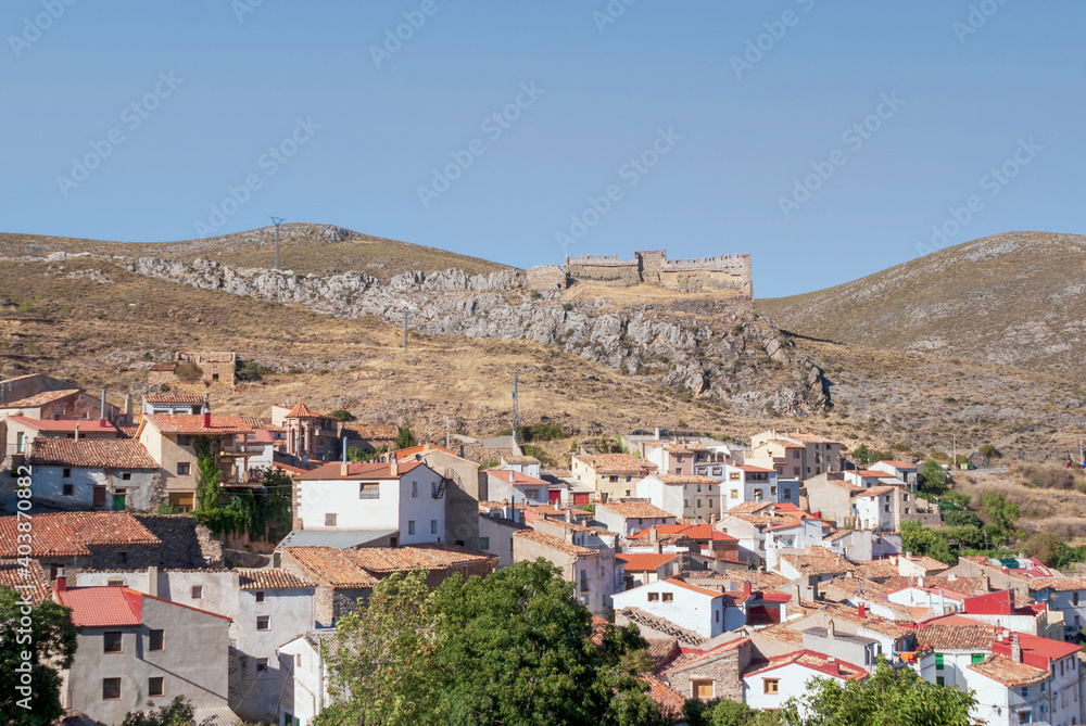 General view of the village of Talamantes with the 12th century castle in the background located in Aragon, Spain
