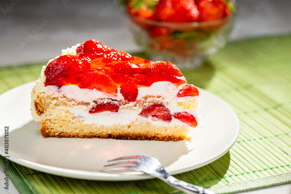 piece of cake on white plate with strawberries piece of cake on white plate with strawberries