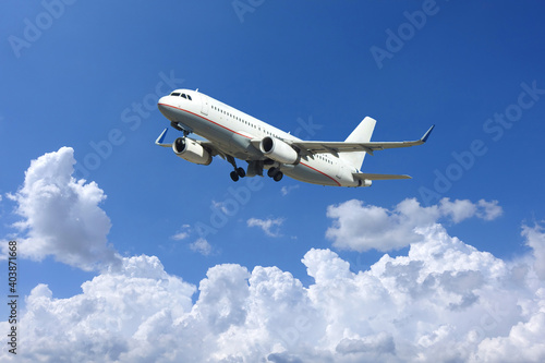 Zoom photo of passenger airplane taking off in deep blue sky and beautiful clouds