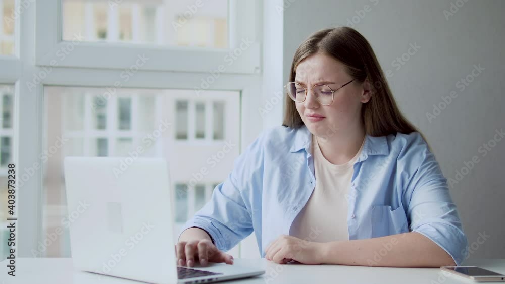 Upset employee reading email on laptop in office, online job search, failure Upset employee reading email on laptop in office, online job search, failure
