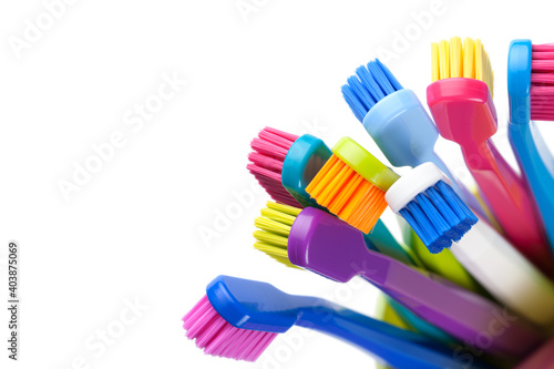 Group Of Colorful Toothbrushes In Cup Isolated