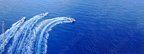 Fotografi Aerial drone ultra wide top down photo of synchronised powerboats cruising in hi