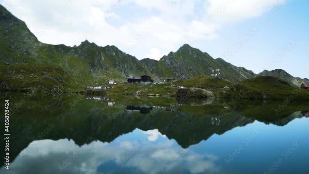 Majestic view of Balea glacier lake near the Transfagarasan road. The mountains are reflected in the water. Majestic view of Balea glacier lake near the Transfagarasan road. The mountains are reflected in the water.