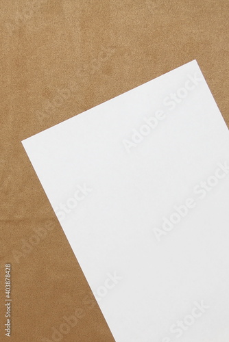 Template of white paper lies diagonally on light brown cloth background. Concept of business plan and strategy. Stock photo with empty space for text and design. © Stanislav