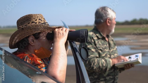 bird watchers with binoculars in nature