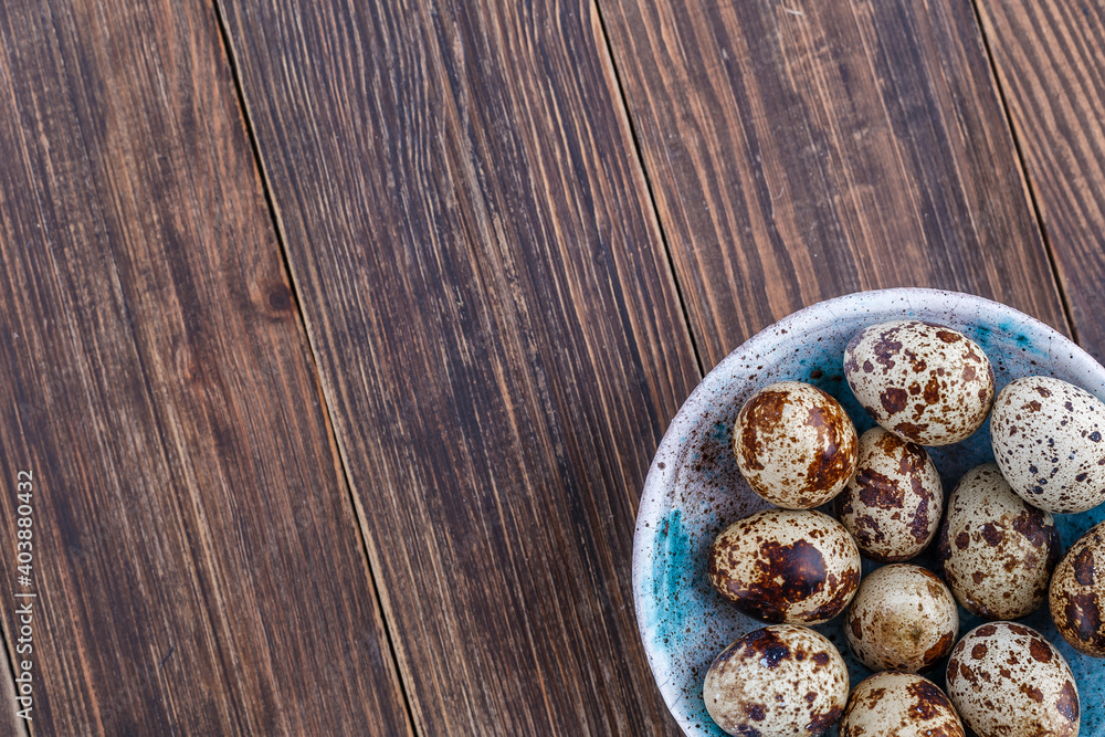 Quail eggs on the wooden plate. Quail eggs can be consumed by frying or boiling. In Indonesia quail eggs called telur puyuh.