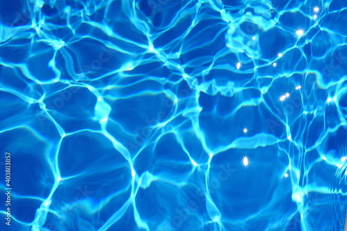 Water abstract background, Swimming pool rippled. Surface of blue swimming pool,background of water in swimming pool. Water background blue. © Sanja