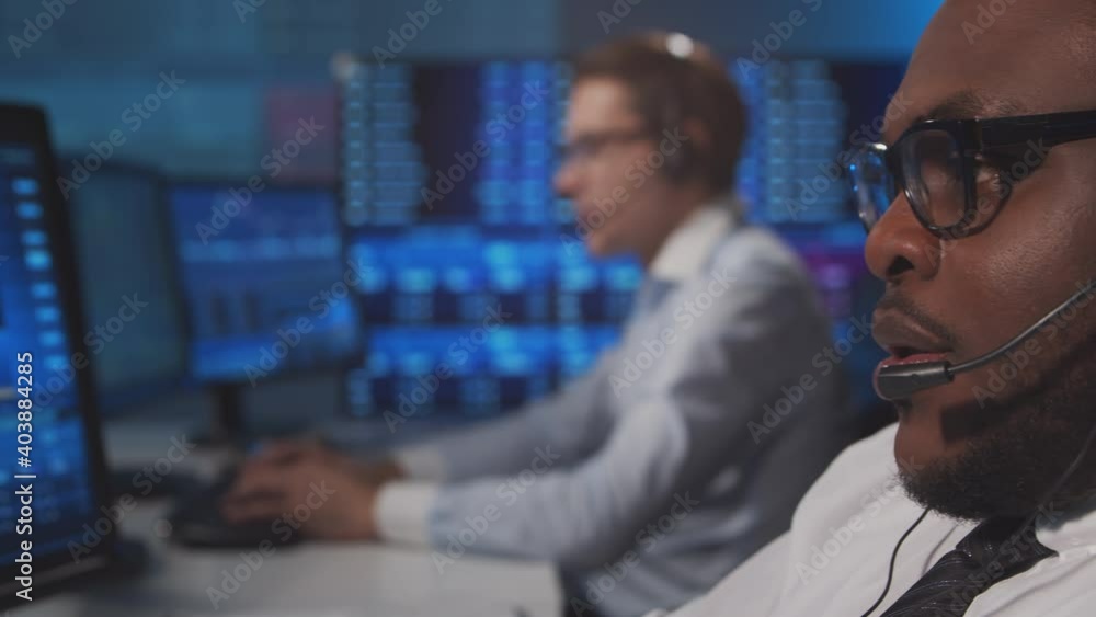 Diverse team of brokers workin in office using workstation and analysis technology. Workplace of professional traders. Global financial markets, business, currency exchange and banking concepts. Diverse team of brokers workin in office using workstation and analysis technology. Workplace of professional traders. Global financial markets, business, currency exchange and banking concepts.