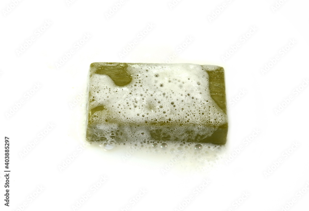 Olive Soap bar with foam isolated on white  background. Wet bar of soap. Antivirus. Coronavirus (CoV). Fighting virus.