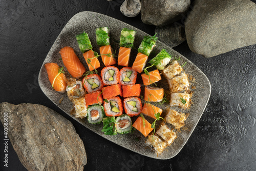 Big sushi set. Sushi rolls and nigiri with salmon, avocado, tobiko caviar, tuna flakes, chuka salad. An Asian classic food with seafood, rice and raw fish fillets. photo