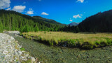 Fisheye panorama of Lotru river  flowing near a beautiful pasture surrounded by the wilderness of Parang Mountains with their spruce forests. Carpathia, Romania