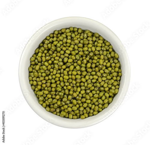 Dry green beans on white background. Organic raw green beans mungo (Vigna radiata) in a bowl nisolated on white background.  photo