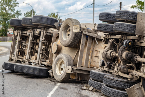view of an overturned truck on an highway in an accident.