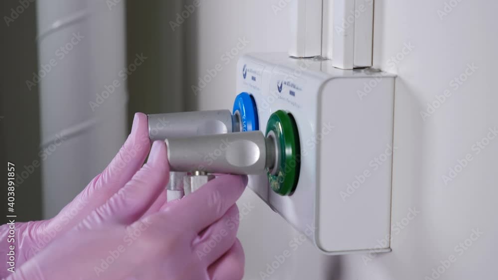 Medical worker hands plugging pipes and pipelines for oxygen, nitrous