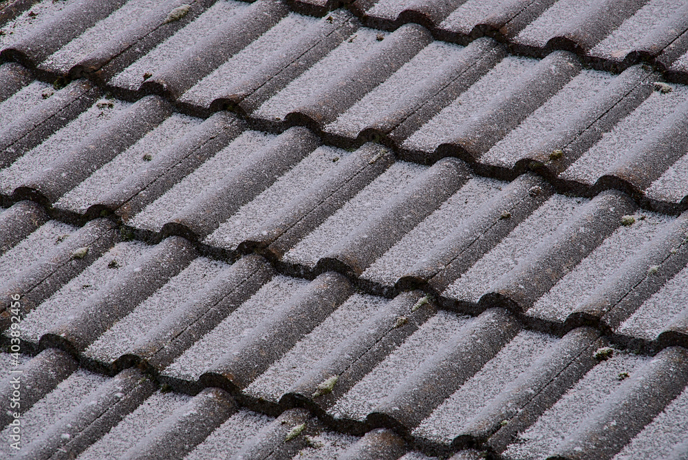 Irish style tile roof texture slightly covered with snow and frost on the last day of 2020, Dublin, Ireland. Diagonal pattern of roof tiling Irish style tile roof texture slightly covered with snow and frost on the last day of 2020, Dublin, Ireland. Diagonal pattern of roof tiling
