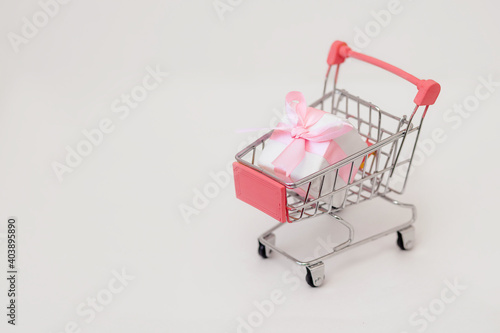 Pink gift box in basket, holiday concept