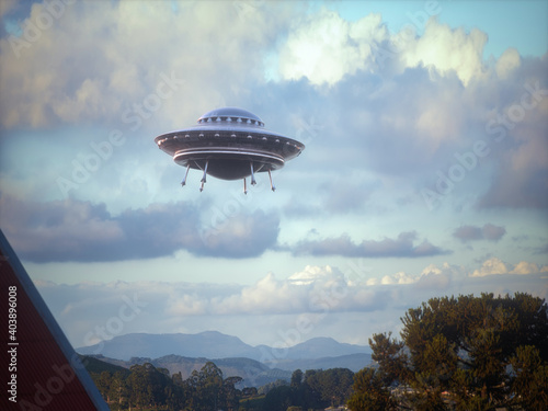 Unidentified flying object flying over the city. Alien spaceship in the shape of a disc made of metallic material. Clipping path included.