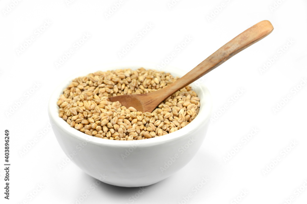 wheat grains in white bowl isolated on white background. wheat grains in white bowl isolated on white background.