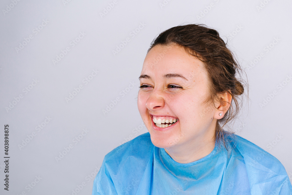 Happy healthcare worker laughs and rejoices on white background with blank side space. Defeating the virus. Happy healthcare worker laughs and rejoices on white background with blank side space. Defeating the virus.