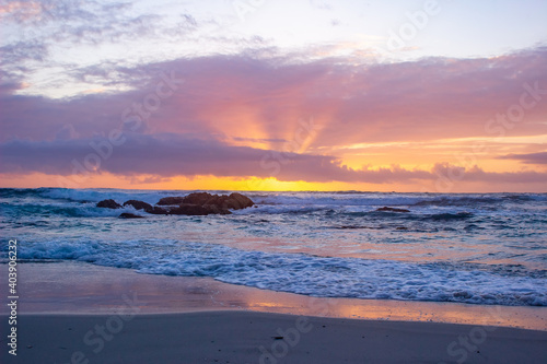 beach sunset behind clouds