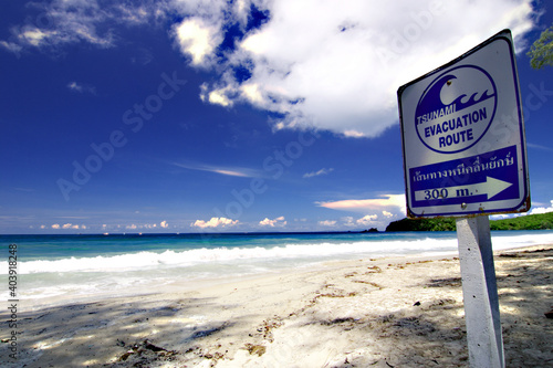 The sign says that tsunami evacuation route 300 meters. Beautiful beach in payam island most popular traveling destination in ranong province,Thailand 