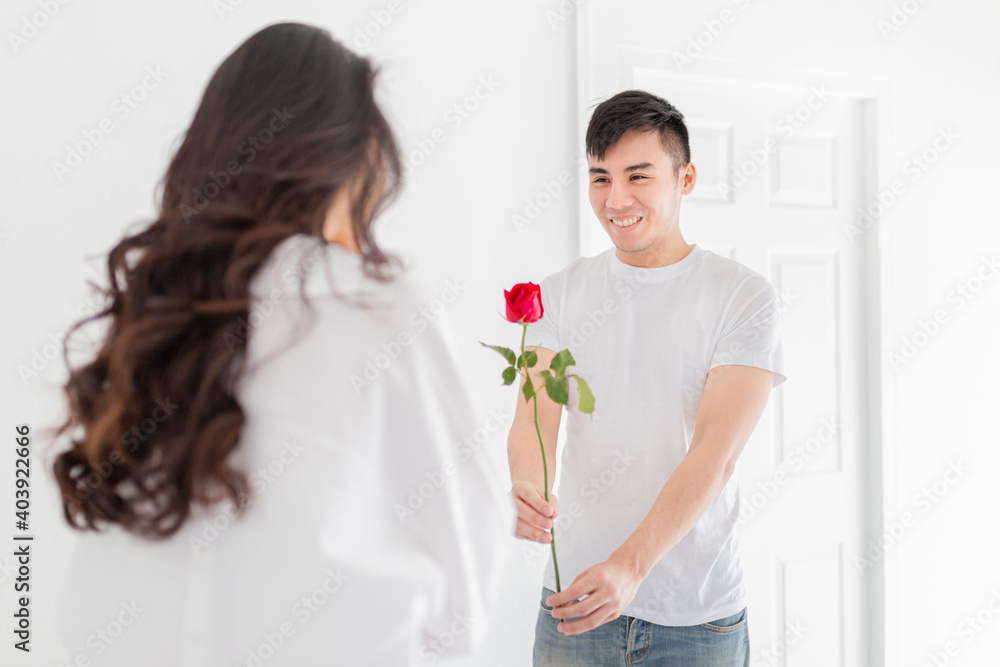asian man send red rose to his girlfriend, asian female feeling surprise, they feeling happy and smile, happiness valentine's day asian man send red rose to his girlfriend, asian female feeling surprise, they feeling happy and smile, happiness valentine's day