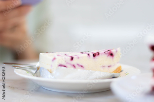 Blueberry Cheesecake is placed on a white plate in the cafe.