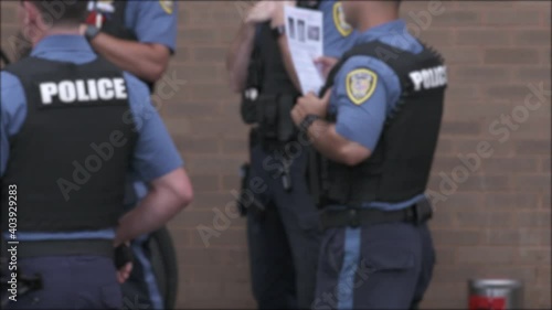 Police Officer Studying Report at Meeting Outside Blurry 4K