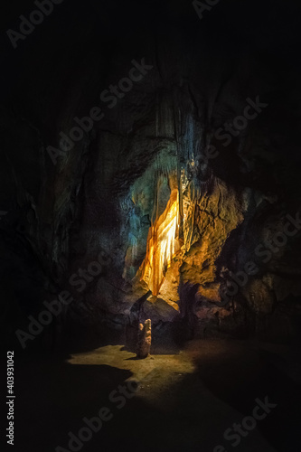 colorful drapery in dark cave illuminated by lights