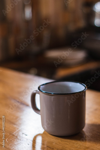 a cup of coffee on a wooden table