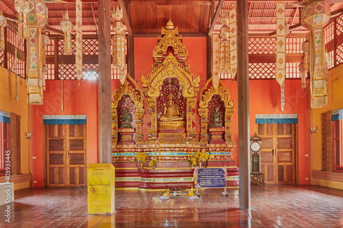 Phayao, Thailand - Dec 6, 2020: Gold Prajao Tanjai Statue in Sanctuary or Chapel at Wat Analayo Temple with Natural Light