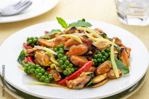Stir-fried mussel meat with herbal vegetables or mussel pad cha Thai