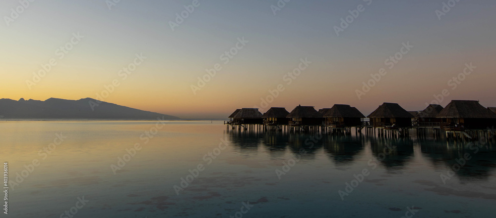 Quiet morning with overwater bungalows on a tropical island lagoon