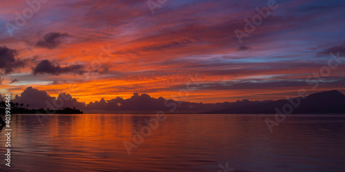 Beautiful sunrise with colorful sky over the ocean in tropical French Polynesia