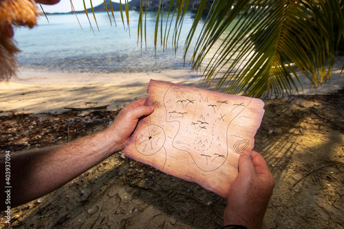 Obraz na plátne Searching for a buried treasure with a map on a deserted tropical island