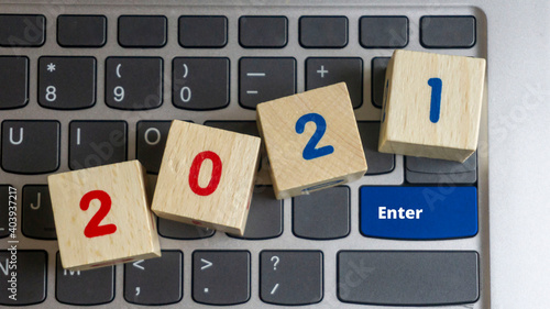 the wooden cube blocks are on the keyboard. Enter key to 2021.