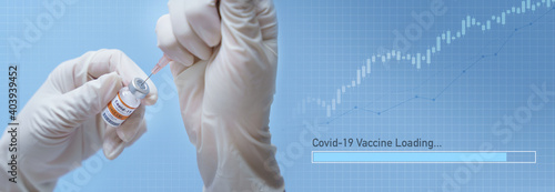 Global economy recovery after Covid 19 vaccines. Hands of a researcher in medical gloves takes shot from a Vaccine vial by needle syringe with graphic loading bar and stock index rising up. Banner. photo