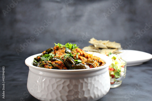 Baingan masala or Baingan curry or Eggplant Curry or Bainki sabzi is very popular Indian vegetarian dish served with roti,bhakhri or chapati. photo