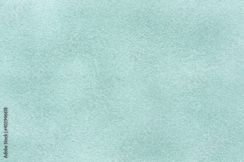 Light blue matte background of suede fabric, closeup. Velvet texture of textile