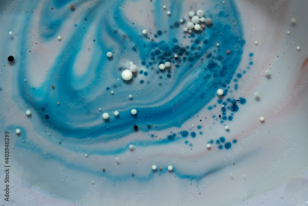 Fototapeta premium Painted Galaxy Art Created in Oil and Milk. Galaxies evolve in this artistic science experiment. Alien landscape. Purple, red and blue abstract formations take shape in an alternate universe.