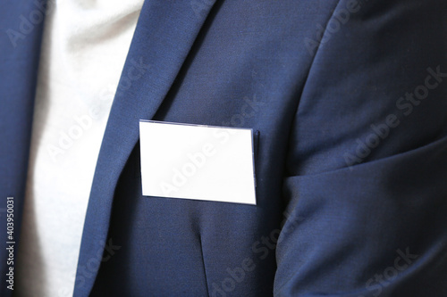 Bild auf Leinwand Elegant man in suit with blank badge, closeup