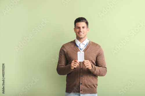 Young man with blank badge ...