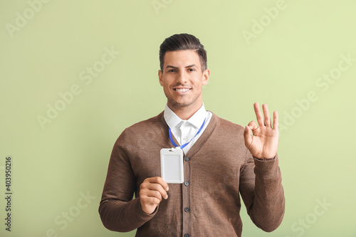 Young man with blank badge ...