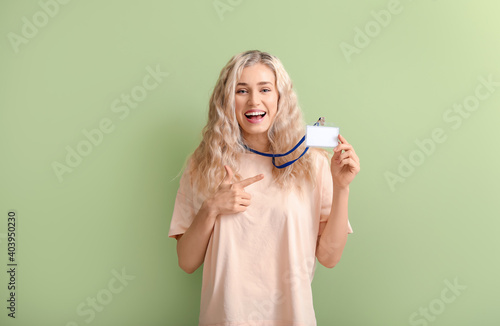 Young woman with blank badg...